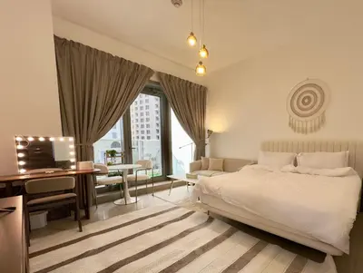 a bedroom with a bed and a desk with a computer at Studio Apartment in Sparkle Tower Dubai Marina in Dubai