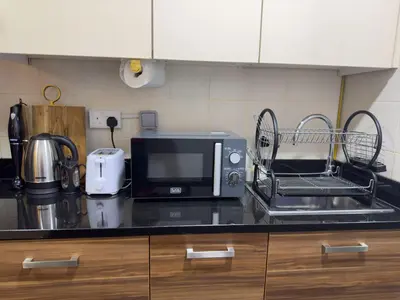 a kitchen counter with a microwave and a sink at Studio Apartment in Sparkle Tower Dubai Marina in Dubai