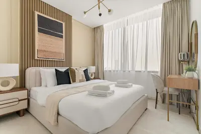 a hotel room with two beds and a desk at Silkhaus Comfy 1BDR at Sky Gardens in DIFC-NEW in Dubai