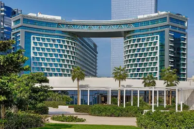 a large building with a walkway over it with palm trees at Spacious 1 bed with seaview in Seven Palm - Palm Jumeirah - IQPRO Holidays in Dubai