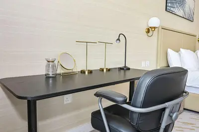 a desk with a chair in a hotel room at NEW Luxury studio - Amazing Palm Views in Dubai