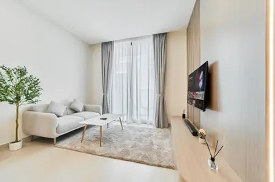a living room with a couch and a table at Chic Studio in Dawn by Binghatti, Heart of JVC in Dubai