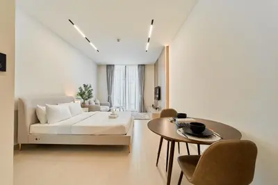 a living room with a couch and a table at Chic Studio in Dawn by Binghatti, Heart of JVC in Dubai