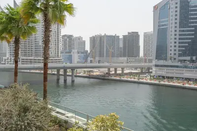 a bridge over a river in a city with buildings at Chic Canal-ViewStudio by Czechin Pool & Gym Access in Dubai