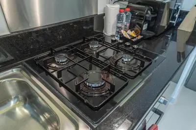 a stove top oven sitting on top of a kitchen counter at Chic Canal-ViewStudio by Czechin Pool & Gym Access in Dubai