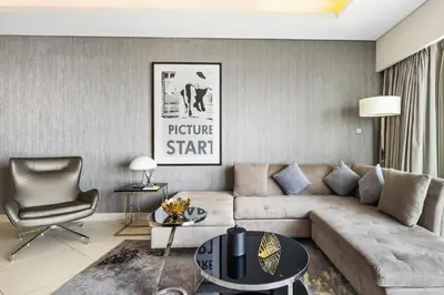 a living room with a couch and a chair at BLVD - Luxury Stay with Burj Khalifa View in Dubai