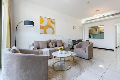 a living room with two couches and a table at Walking Distance to Circle Mall and Community Parks, 18 Minute Drive to Dubai Marina and JBR Beach, Crystal Residence, JVC by Deluxe Holiday Homes in Dubai