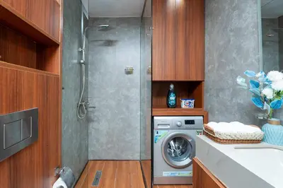 a bathroom with a washing machine and a sink at Modern 1BR with City View - Balcony - Near Metro in Dubai