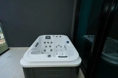 a white sink in a bathroom with a mirror at Apt in Trillionaire Residences with Private Jacuzzi in Dubai