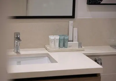 a bathroom counter with a sink and a mirror at Luxury Burj Crown Suites by Maison Aurora in Dubai