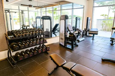 a gym with several rows of exercise equipment in a room at Serene Ocean Views 2BR Emaar Beachfront in Dubai