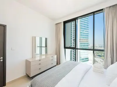 a bedroom with a bed and a large window at Downtown views 1 Bedroom 5 PAX connect to Dubai mall in Dubai