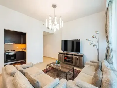 a living room with a couch and a tv at Downtown views 1 Bedroom 5 PAX connect to Dubai mall in Dubai