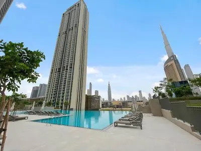 a large swimming pool in a city with buildings at Downtown views 1 Bedroom 5 PAX connect to Dubai mall in Dubai