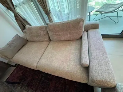 a couch sitting in a living room next to a window at Downtown views 1 Bedroom 5 PAX connect to Dubai mall in Dubai