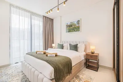 a bedroom with a large bed and a large window at Serene and Stylish Home in the Heart of JVC in Dubai