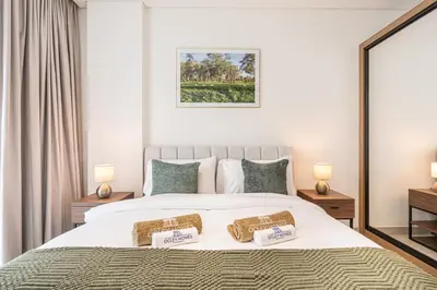 a bedroom with a bed with two pillows on it at Serene and Stylish Home in the Heart of JVC in Dubai