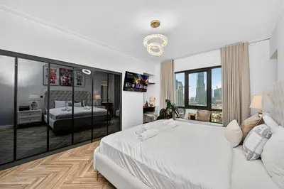 a bedroom with a white bed and a large window at Stunning 2 Bdr Luxury Burj Khalifa view in Dubai