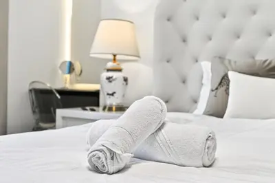 a persons legs in white socks on a bed at Stunning 2 Bdr Luxury Burj Khalifa view in Dubai