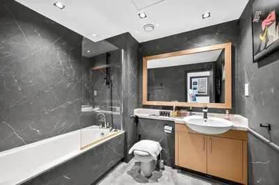 a bathroom with a sink and a tub and a toilet at Stunning 2 Bdr Luxury Burj Khalifa view in Dubai