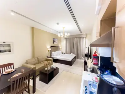 a living room with a couch and a table at Elite Residency- A Cosy Studio in Downtown in Dubai