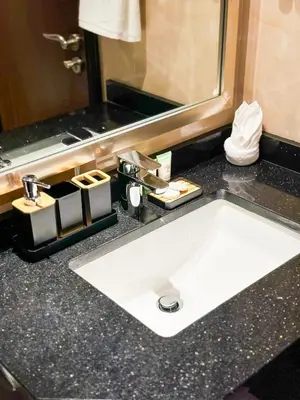 a bathroom counter with a sink and a mirror at Elite Residency- A Cosy Studio in Downtown in Dubai