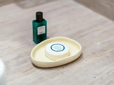 a bottle of soap sitting on a wooden table at Dubai Hills Mansion Cinema, Gym & Luxe Pool in Dubai