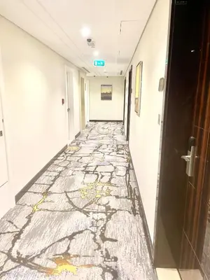 a corridor in a hospital with a painting on the floor at Luxury Studio with Pool, Gym & Downtown Access in Dubai