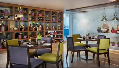 a dining room with a table and chairs at Luxury Studio with Pool, Gym & Downtown Access in Dubai