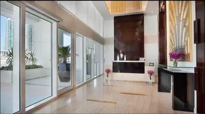 a large room with a lobby with a person on the wall at Luxury Studio with Pool, Gym & Downtown Access in Dubai