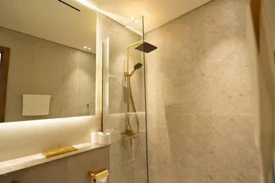a shower with a glass door in a bathroom at Binghatti Amber in JVC, 15 Min to Marina in Dubai