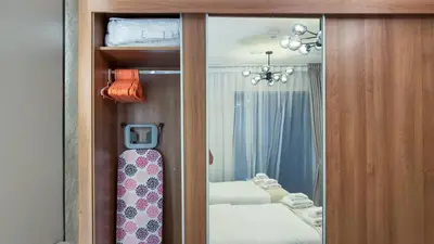 a room with a closet with a tie and a mirror at Large Flat in High Floor with view to Marina Canal & Beach sleep 8px in Dubai