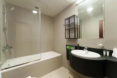 a bathroom with a sink and a shower and a tub at Large Flat in High Floor with view to Marina Canal & Beach sleep 8px in Dubai