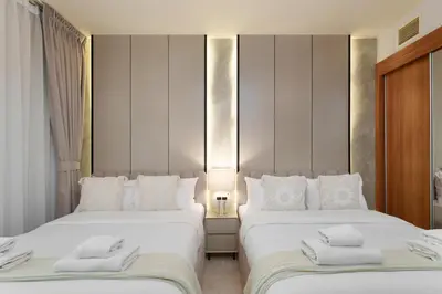 a bedroom with two beds with towels on them at Large Flat in High Floor with view to Marina Canal & Beach sleep 8px in Dubai