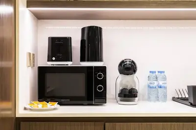 a microwave oven sitting on a counter in a kitchen at SettlerHomes - 14F Ocean View Gem With Private Beach in Dubai