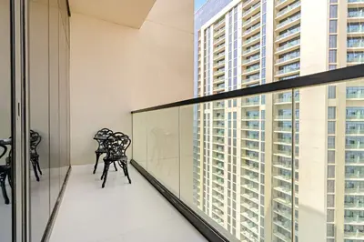 a balcony with chairs and a view of a building at Silkhaus Studio Escape in Business Bay in Dubai