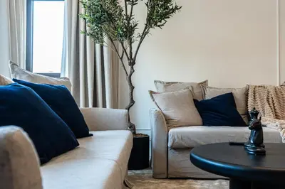 a living room with two couches and a table at Spacious 2 bedroom apartment I Palm Jumeirah in Dubai