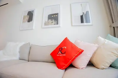 a living room with a couch with pillows on it at Binghatti Corner in Dubai