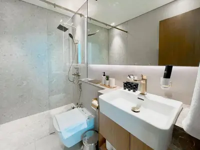 a bathroom with a sink and a toilet and a mirror at Modern 1BR Apt in Binghatti Gardenia with Pool & Gym! in Dubai