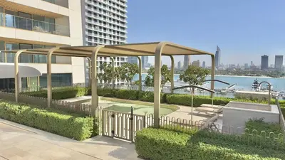 a pavilion in front of a building next to at Elegant 2BR, Grand Bleu, Coastal Elegance in Dubai