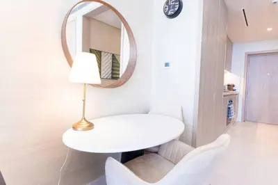 a white table and chairs in a room with a mirror at Sky-High Elegant Suite at Palm Tower in Dubai