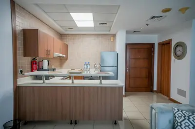 a kitchen with a counter and a refrigerator at Stylish 1BHK in Sulafa Tower at Dubai Marina in Dubai