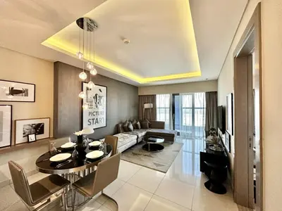 a living room with a table and a couch at Luxury 1BHK in Damac Paramount Towers, Business Bay in Dubai
