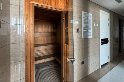 a walk in sauna in a building with a door at Sleek and Spacious Sports City Studio in Dubai