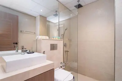 a bathroom with a shower and a sink and a toilet at Stylish Studio in JVC Bright, Cozy and Convenient in Dubai