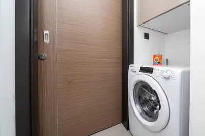 a door to a laundry room with a washing machine at Modern JVC 1-Bed Pool, Gym and Family Amenities in Dubai