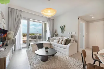 a living room with a couch and a table at Boho Comfort - 1BR with Gym, Pool, Tennis, Yoga and Dubai Mall access in Dubai