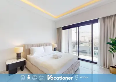 a bedroom with a large bed and a large window at Azizi Riviera 61 - Serene Studio in Meydan in Dubai