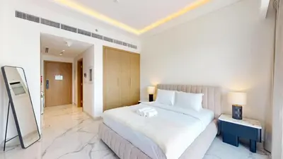 a bedroom with a large white bed in a room at Azizi Riviera 61 - Serene Studio in Meydan in Dubai