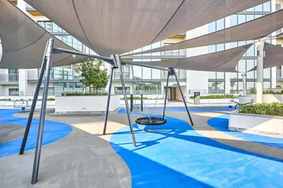 a playground in the courtyard of a building at STAY BY LATINEM Luxury 1BR Holiday Home CB 2001 Near Burj Khalifa in Dubai